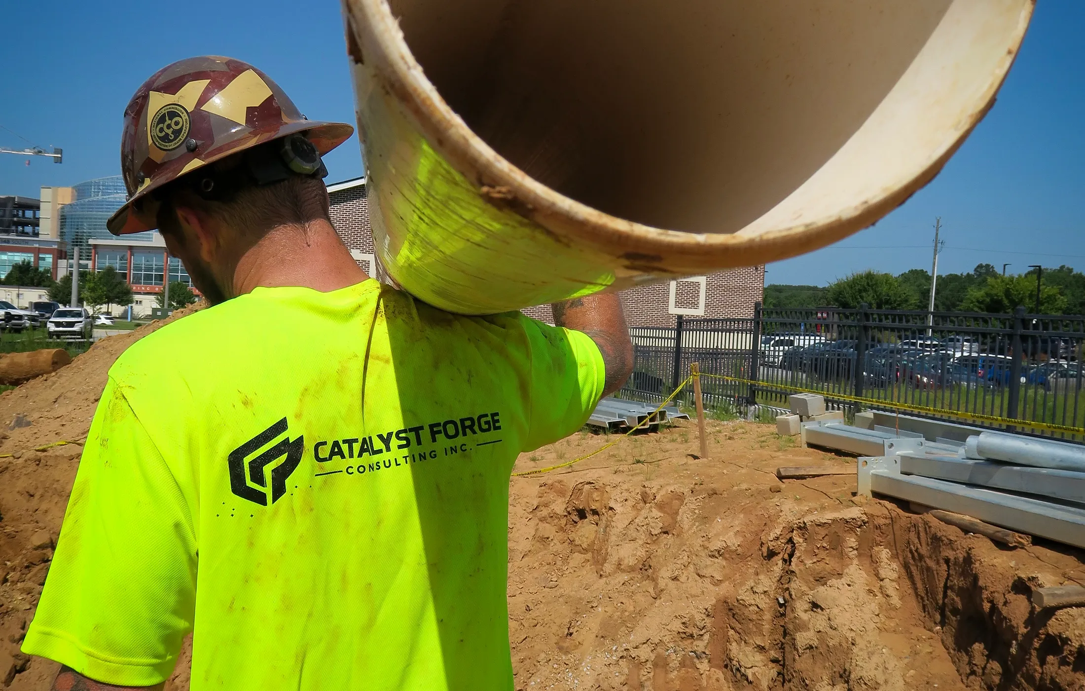 Catalyst Forge crew member carrying utility pipe at an active hotel project in Paulding County, Georgia
